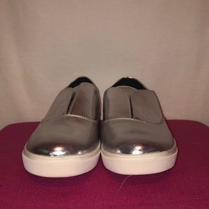 Silver walking shoes with silly emoji inside